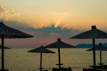 Parasol at the beach sunset