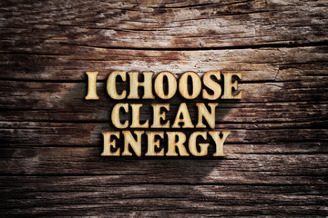 I choose clean energy. Words on old wooden board.