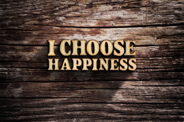 I choose Happiness. Words on old wooden board.