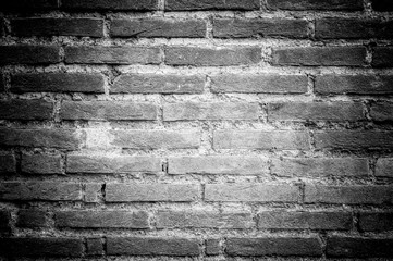 Artistic black and white edit of a brick wall texture, with a vi