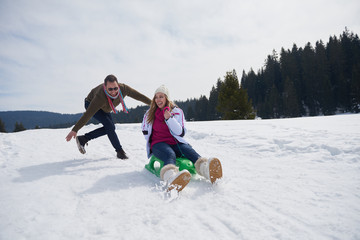 Fototapeta na wymiar happy young couple having fun on fresh show on winter vacation