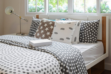 bedroom interior design with polka dot pillows on bed and decora © worldwide_stock