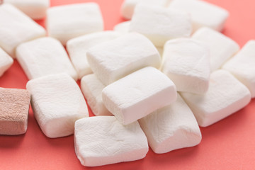 Pile of original marshmallows in red pastel background.