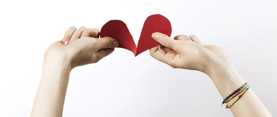 Woman hands tearing paper heart letterbox