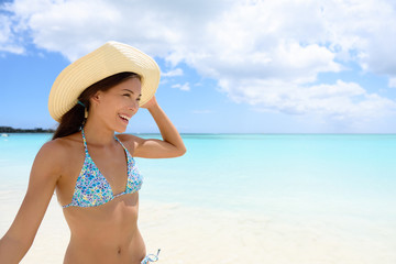 Woman in hat on the beach - girl having fun in sun