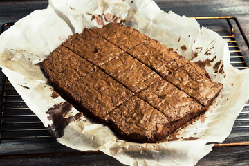 Chocolate brownie hot from oven on wooden table