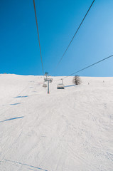 Ski lifts durings bright winter day