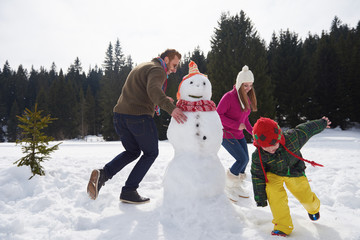 happy family building snowman
