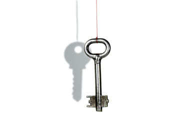 Key and shadow. Optical illusion on a white background