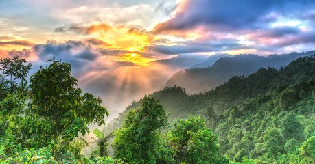 Sunrise on Yen Bai Heaven Gate peaks when the sun rises over the valley radiates ray with a bright yellow color to the highest forest area of Yen Bai, Vietnam