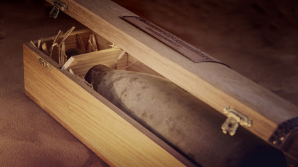 Detail of an Old archive dusty wine bottle in a wooden box, lit by a candlelight