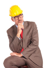 side view of a thoughtful construction engineer