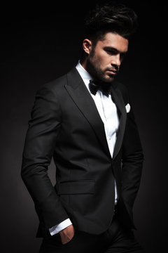 elegant business man posing on black background