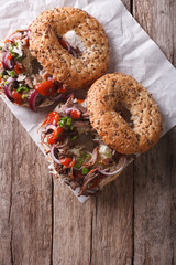 Bagels with Pulled pork and sauce on the table. vertical top view
