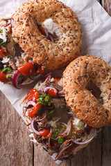 Bagels with Pulled pork and sauce close-up vertical top view
