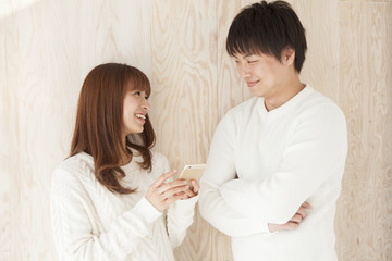 Young couple laughing happily face to face
