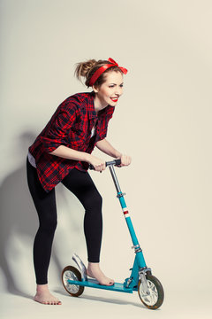 Pretty Young Woman With Scooter