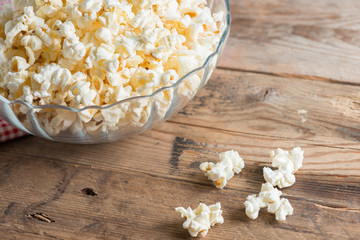 Popcorn in bowl on a wood table. selective focus..
