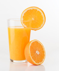 glass of orange juice and orange pieces