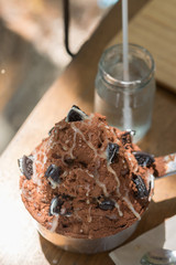 Shaved ice dessert topping with powder chocolate and cookie in p