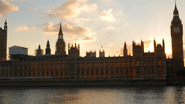 Camera pans across the facade of Parliament to Westminster Bridge in London and at sunset. Shot in 4K