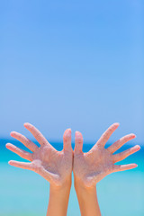 Female open hand on blue sea background