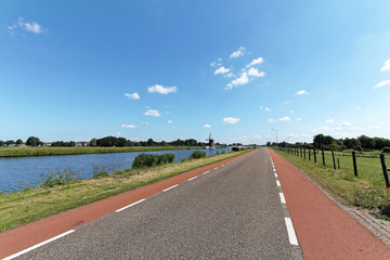 Long road near to dyke in Amsterdam countryside