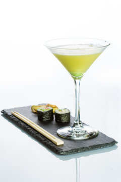 Yellow Cocktail With A Set Of Sushi On White Background