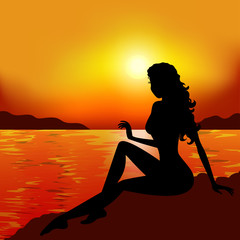 Beautiful woman silhouette at sunset
