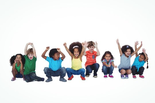 A Row Of Children Crouching Down Together