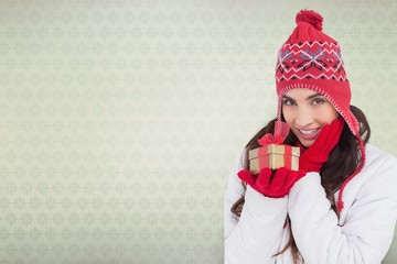 Brunette in winter clothes holding gift