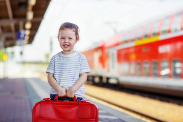 Cute little girl on a railway station.