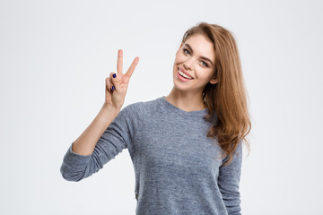 Smiling woman showing peace sign