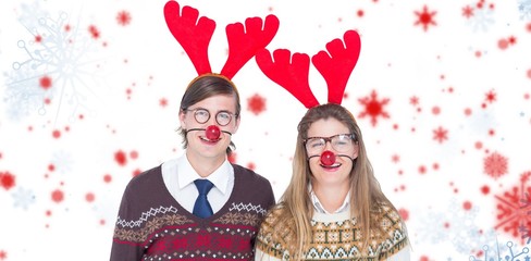 Festive couple wearing red reindeer horn