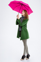 Smiling woman standing with pink umbrella