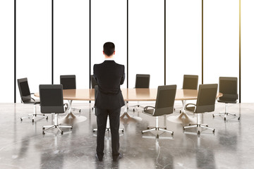 Businessman in conference room with furniture