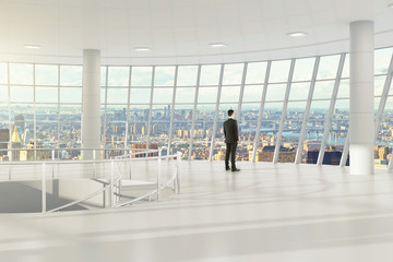 Obraz premium Man in modern light empty office with city view