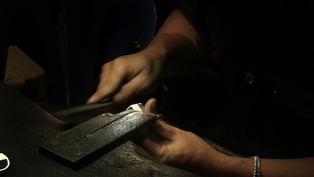 man making jewelry