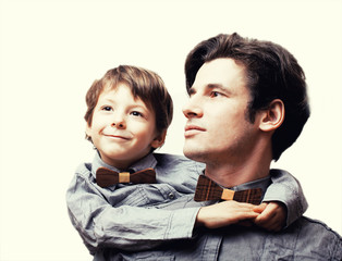 father with son in bowties on white background, casual look family