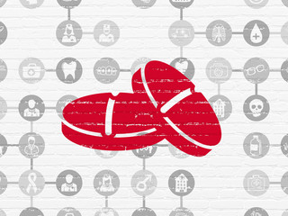 Healthcare concept: Pills on wall background