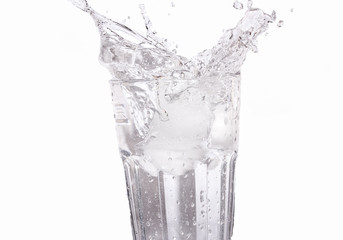 Ice cube splash in cup of water