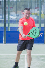 man playing paddle tennis.