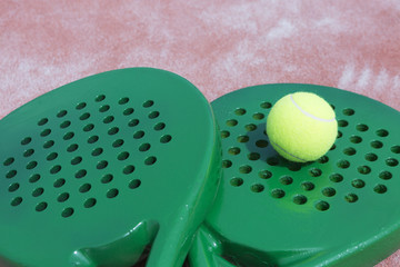paddle rackets and ball.