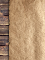 Creased handmade paper on wooden wall background