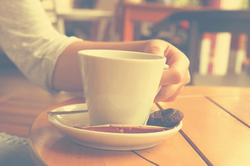 Urban girl drinking a coffee outdoors.