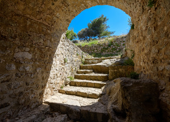 Rocky stairs - an entrance at Angelokastro castle, Corfu, Greece. - 94926712