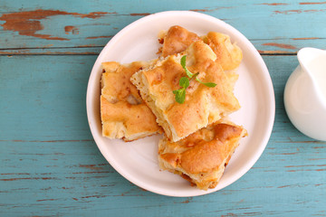 homemade apple pie (charlotte) on a blue wooden background