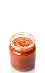Spaghetti sauce in a mason jar over white background