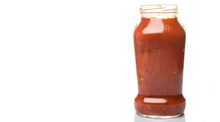 Spaghetti sauce in a glass bottle over white background