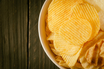 potato chips on wood - soft focus with vintage film filter